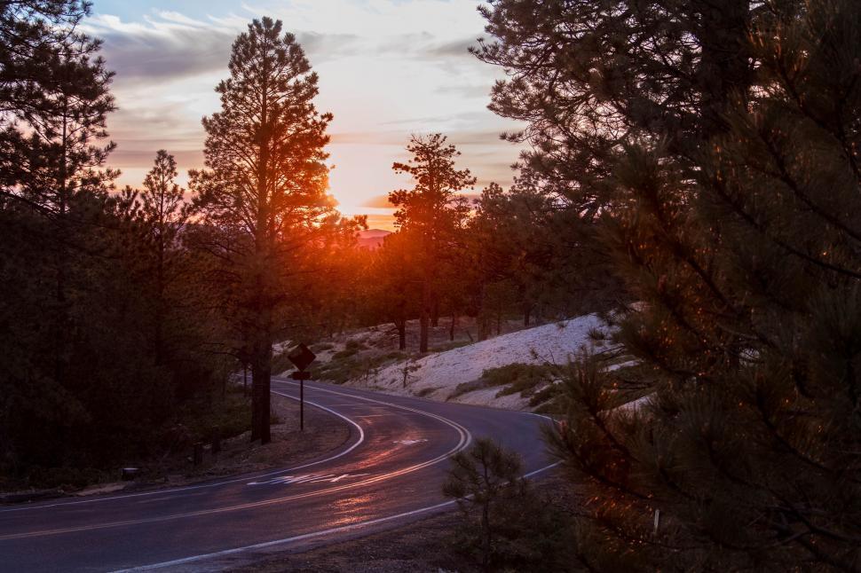 Free Image of Sun Setting Over Winding Road 