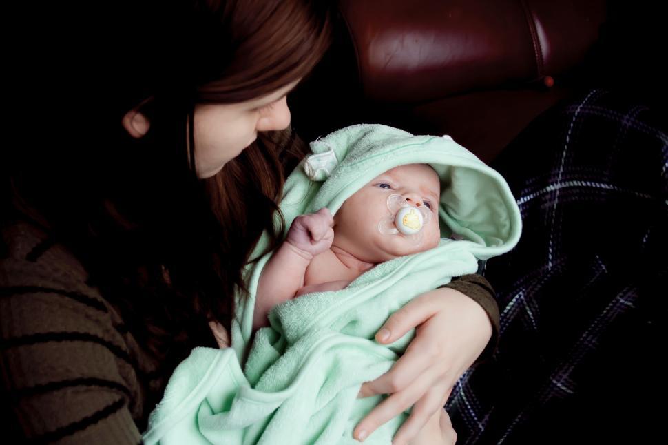 Free Image of Woman Holding Baby Wrapped in Blanket 