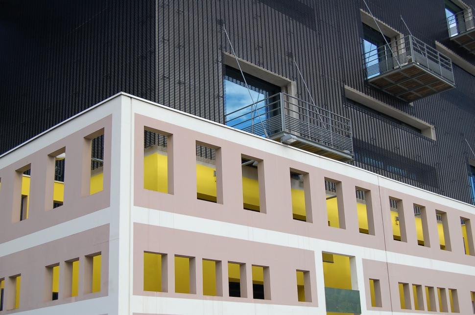 Free Image of Building With Yellow Windows and a Fire Escape 