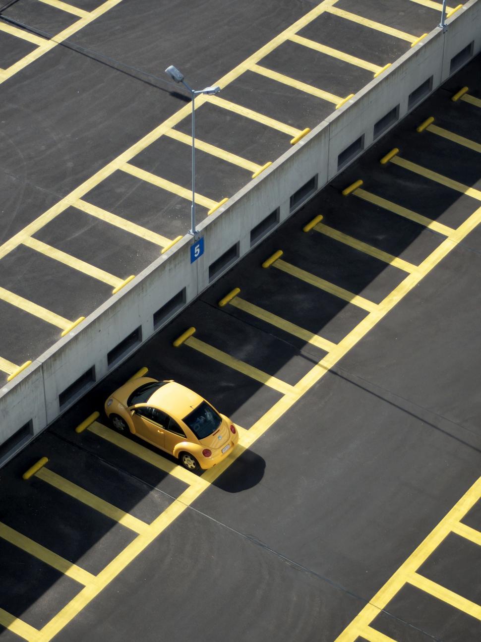Free Image of Yellow Car Parked in Parking Lot 