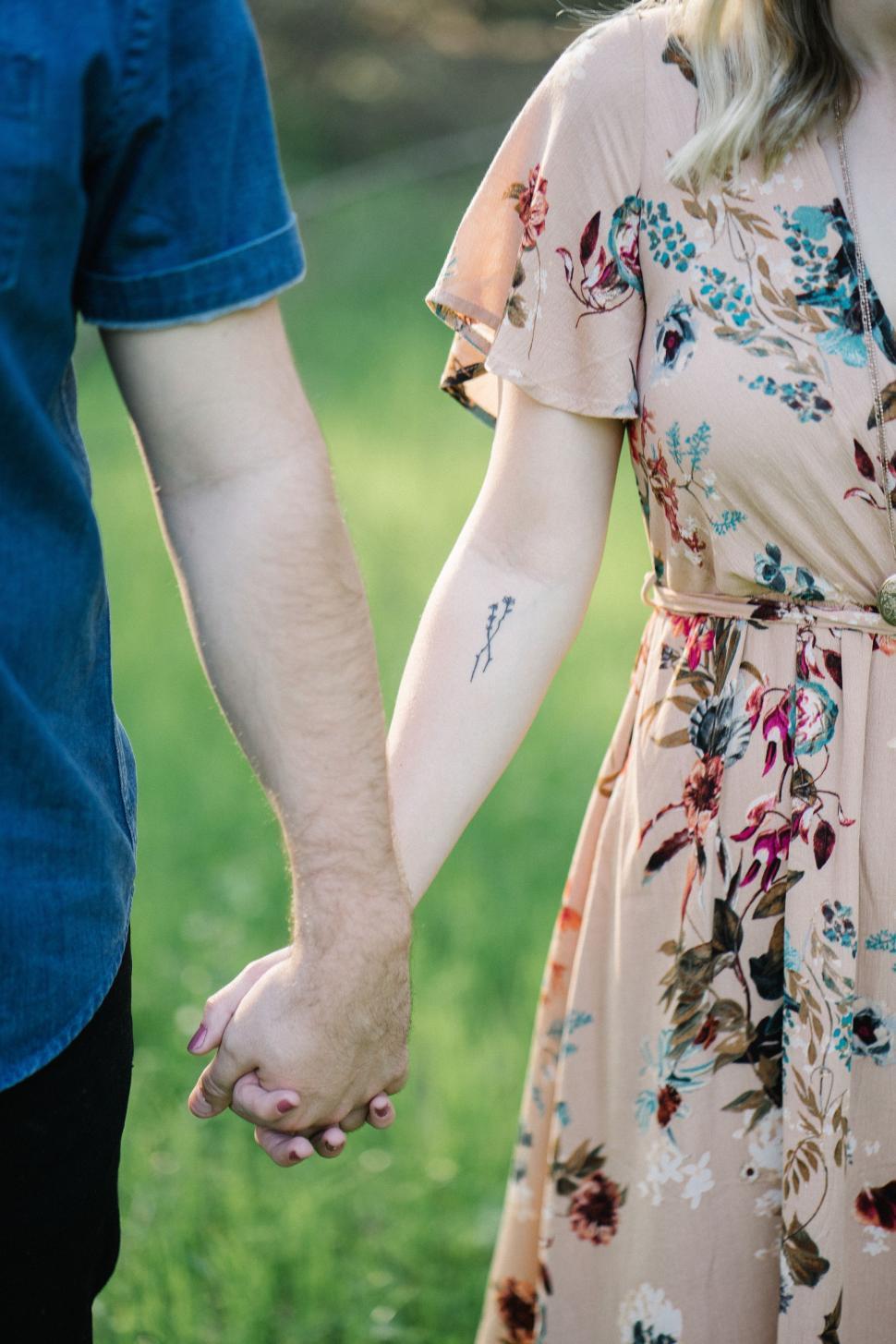 Free Image of Man and Woman Holding Hands in a Field 