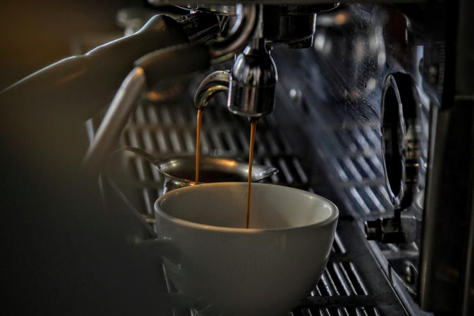 Free Image of Coffee Being Poured Into Espresso Machine 