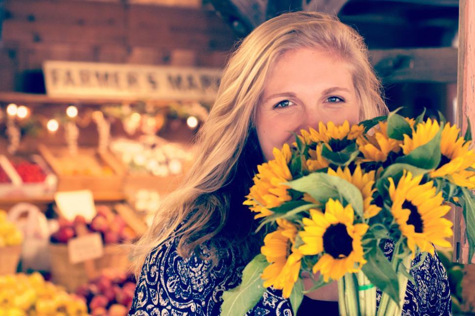 Free Image of Woman Holding Bouquet of Sunflowers 