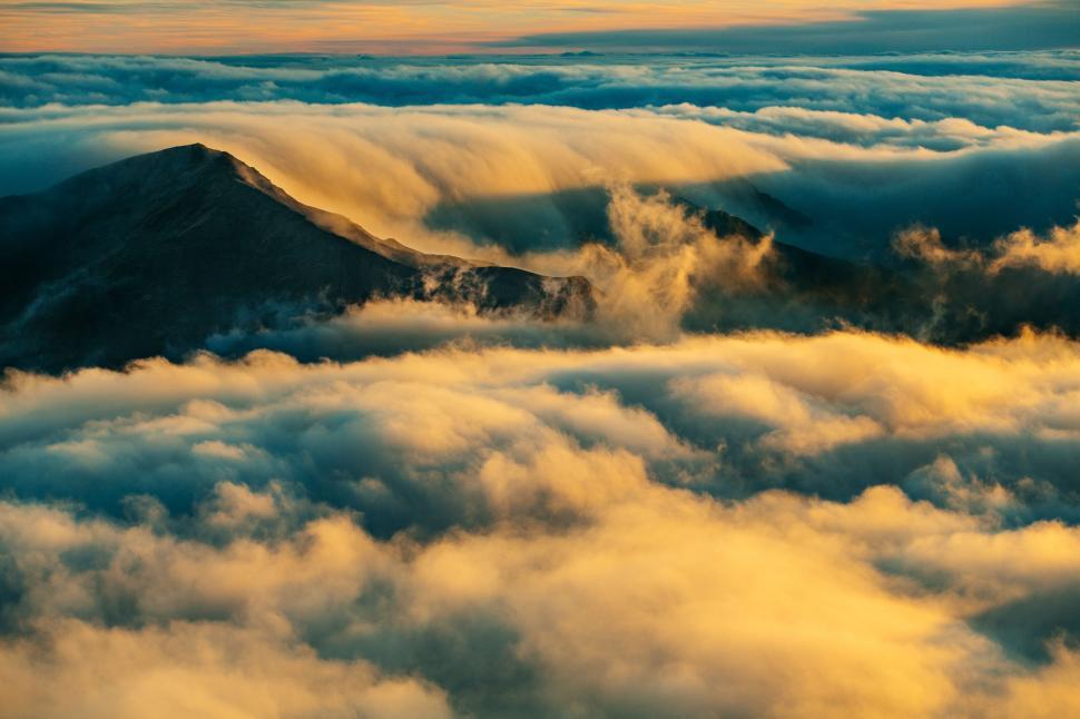 Free Image of Clouds Enveloping Mountain Peak 