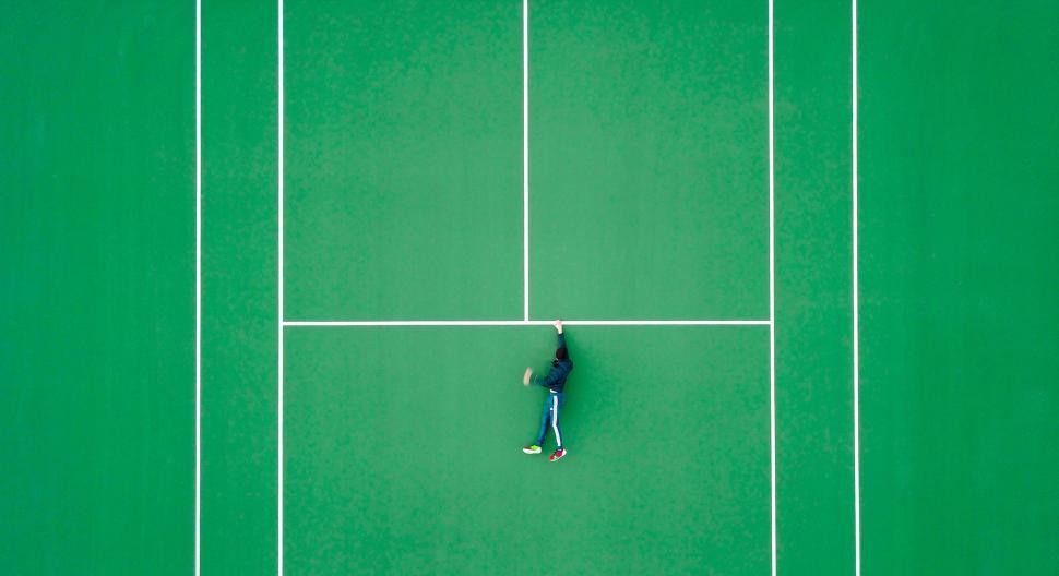 Free Image of Man Standing on Tennis Court Holding Racquet 