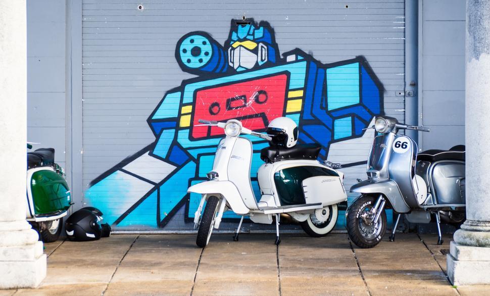 Free Image of Scooter Parked in Front of Robot Mural 
