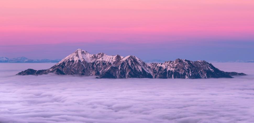 Free Image of Mountain Peak Covered in Clouds 