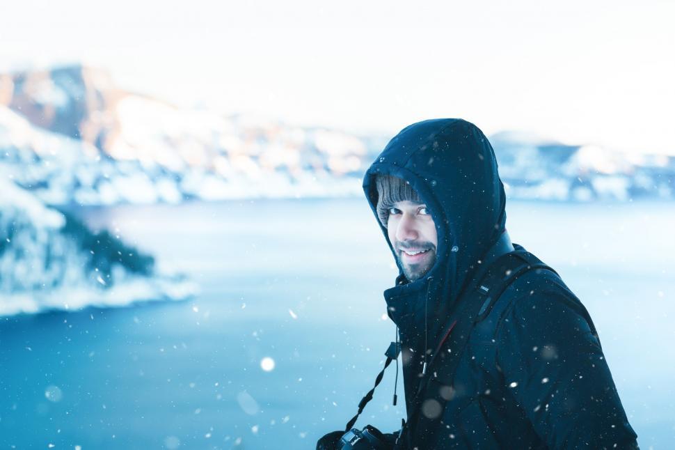 Free Image of Man in Hooded Jacket Standing in Snow 