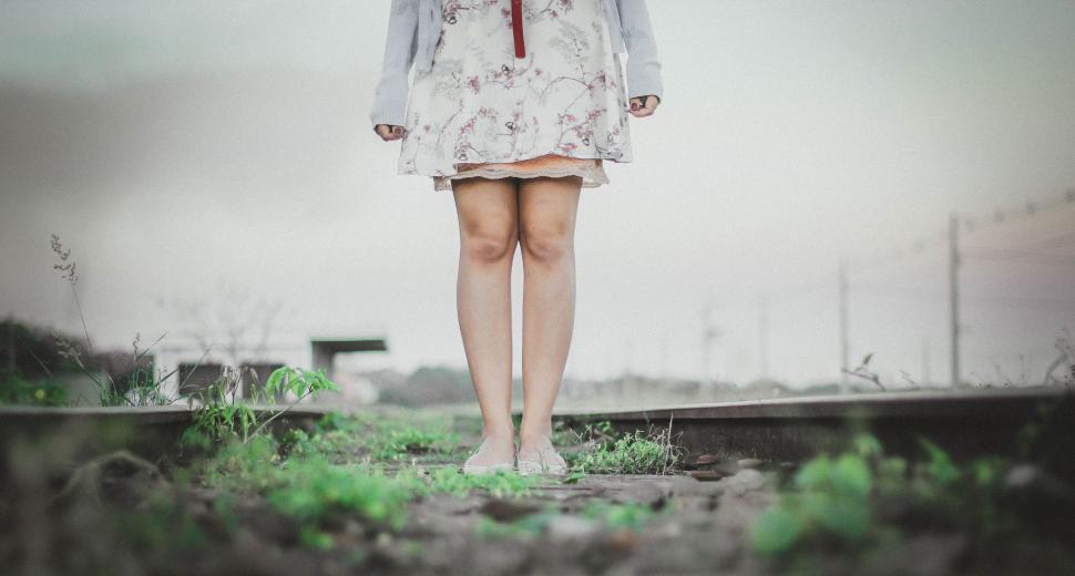 Free Image of Woman Standing on Train Track Holding Umbrella 