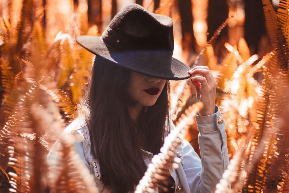 Free Image of Woman Wearing Hat in Field of Tall Grass 
