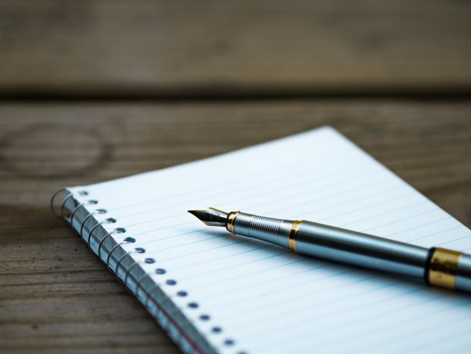 Free Image of Pen Resting on Top of Notebook 