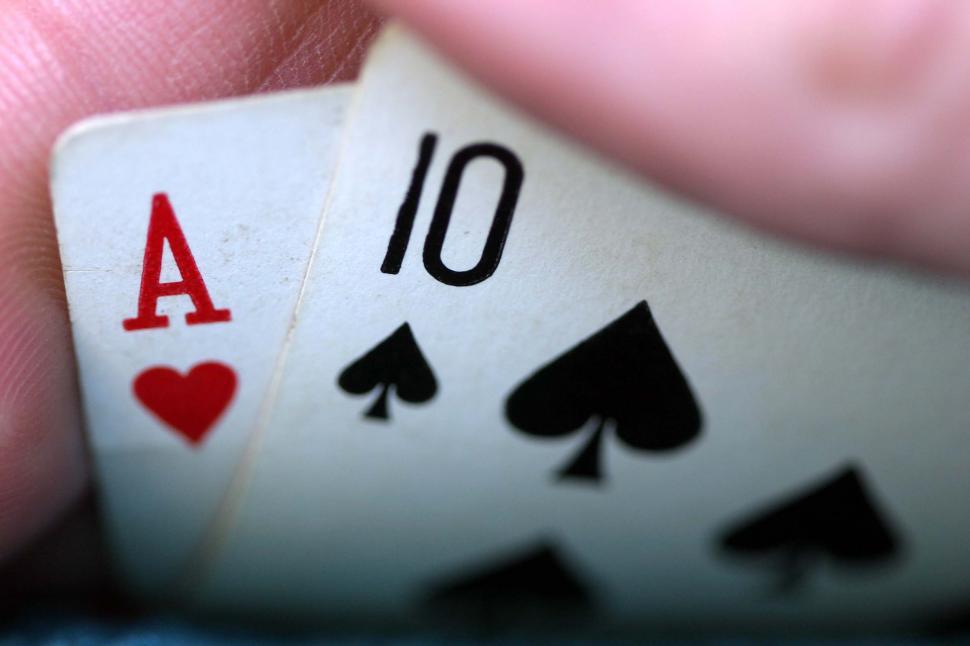 Free Image of Hand Holding Two Playing Cards 