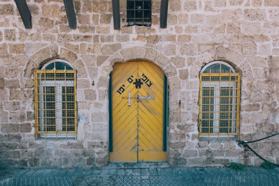 Free Image of Yellow Door in Front of Stone Building 