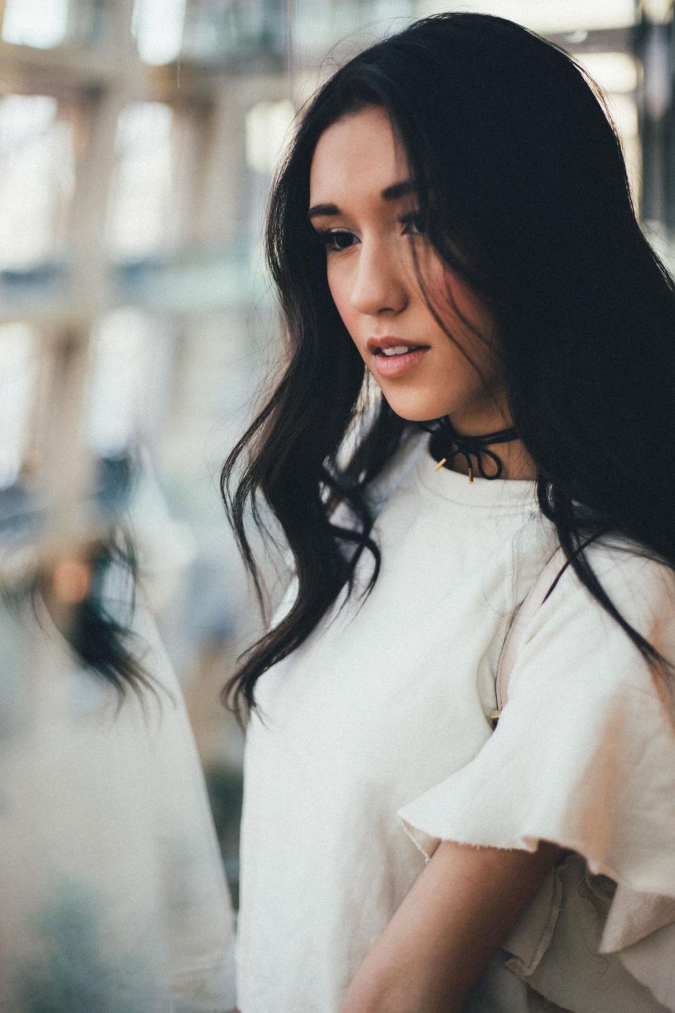Free Image of Woman With Long Black Hair Wearing White Top 