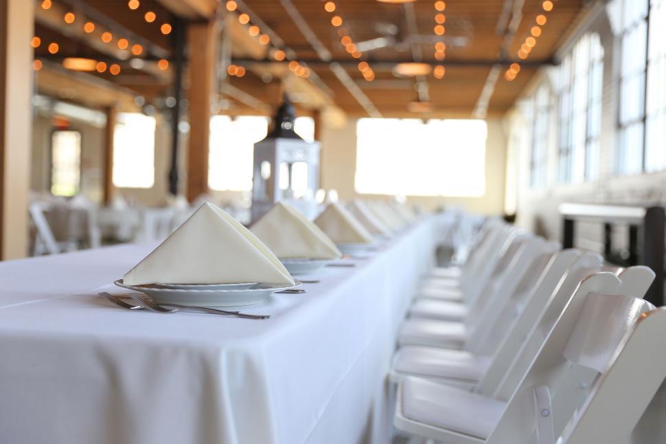 Free Image of Long Table With White Tablecloths and Silverware 