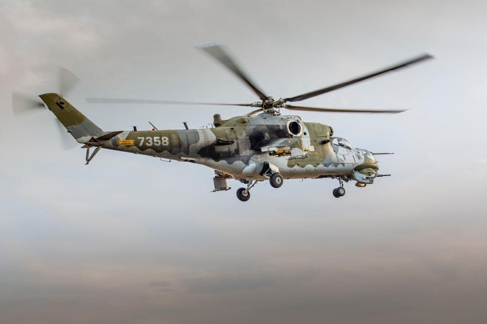 Free Image of Military Helicopter Flying Through Cloudy Sky 