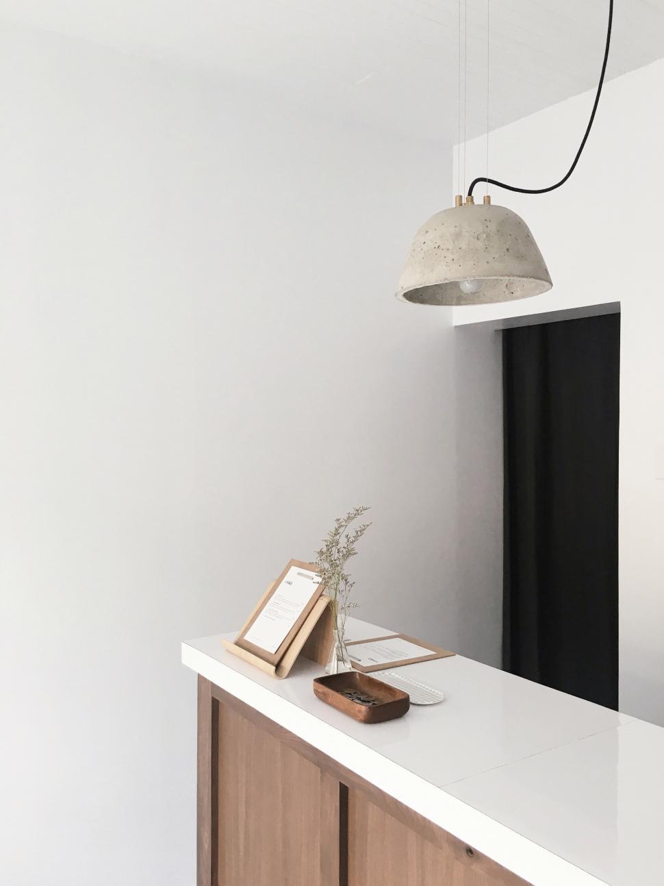 Free Image of White Room With Wooden Cabinet and Lamp 
