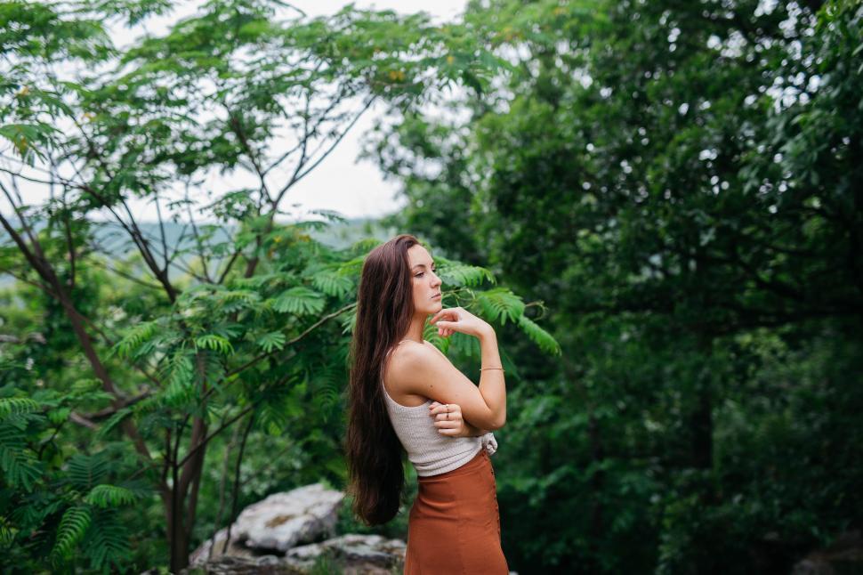 Free Image of Woman in Brown Dress Standing in Forest 