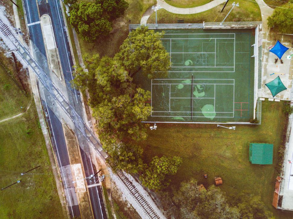 Free Image of Aerial View of a Tennis Court Surrounded by Trees 