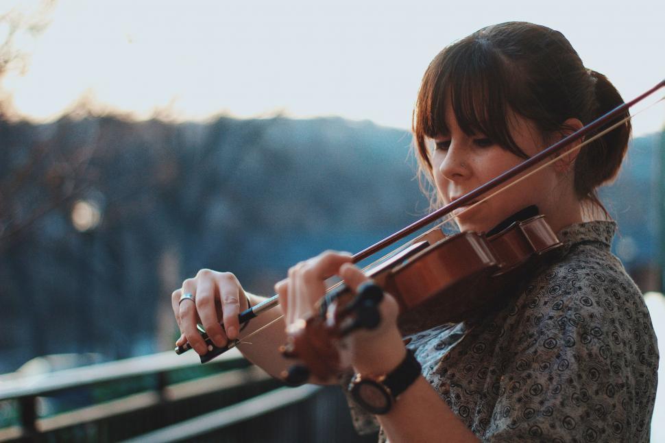 Free Image of Woman Playing Violin on Bridge 