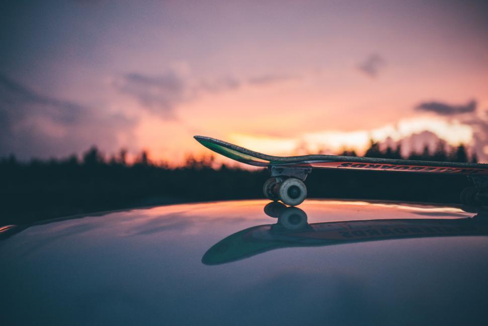 Free Image of Skateboard on Roof of Car 