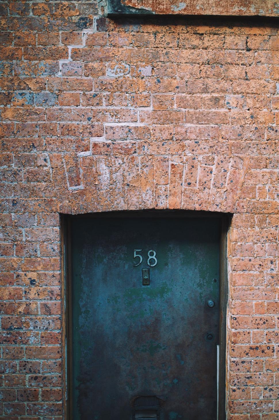 Free Image of Black Door in Brick Wall 