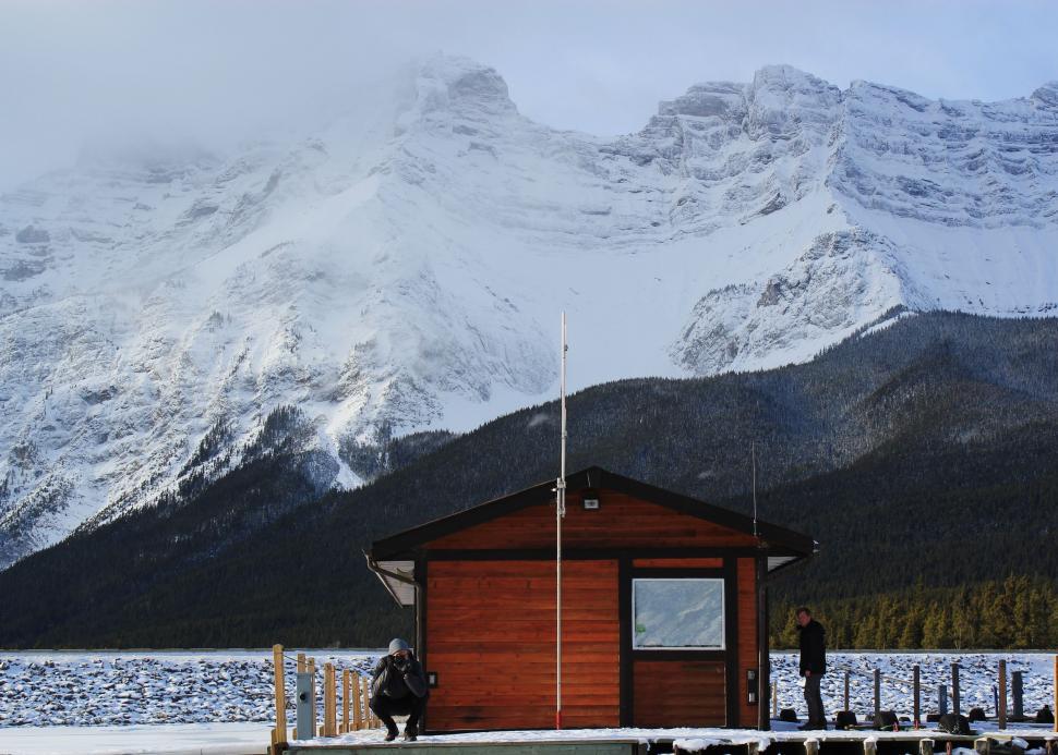 Free Image of Cabin on Dock With Mountain Range in Background 