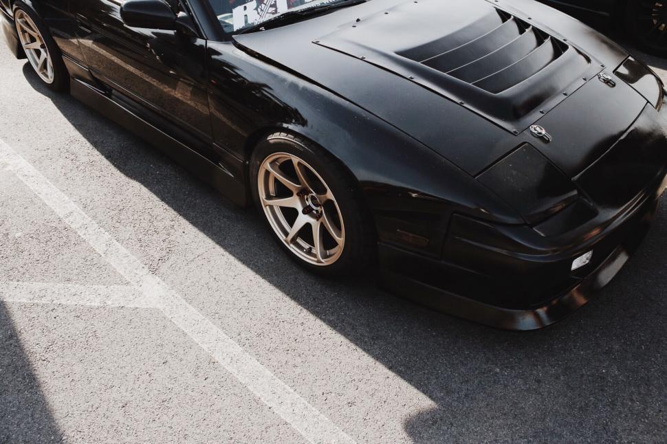Free Image of Black Sports Car Parked in Parking Lot 