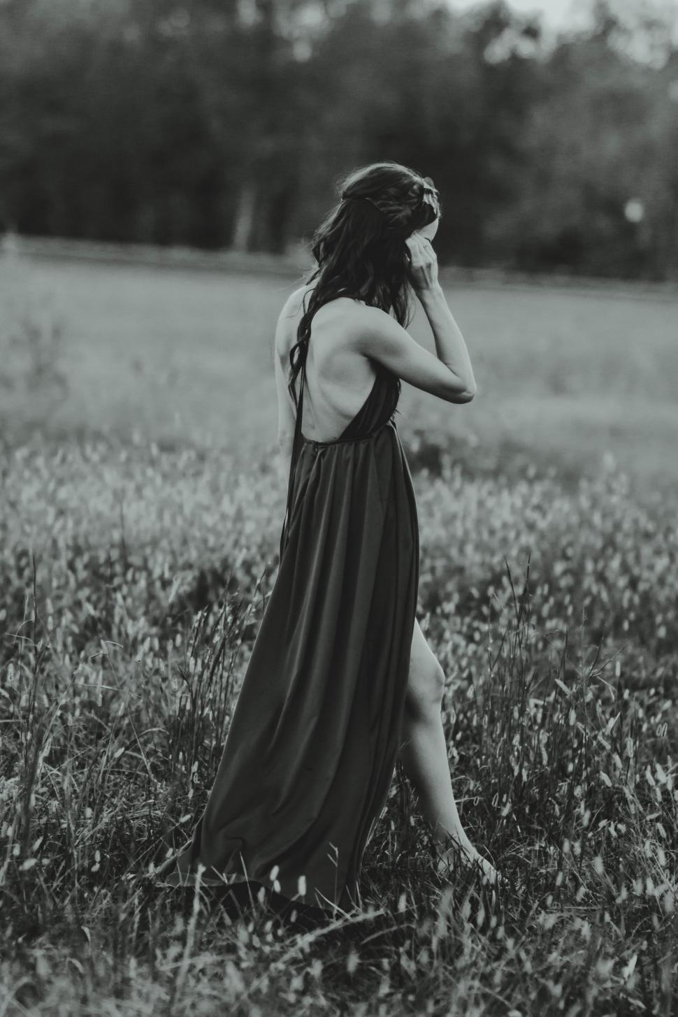 Free Image of Woman Standing in Long Dress in Field 