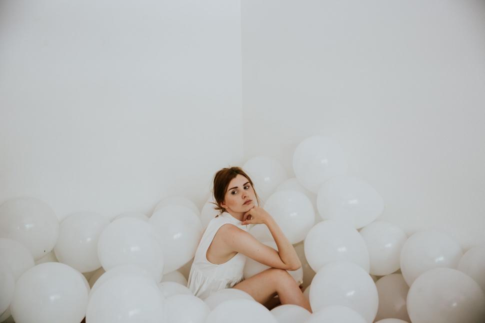 Free Image of Woman Sitting in Bubble-Filled Room 