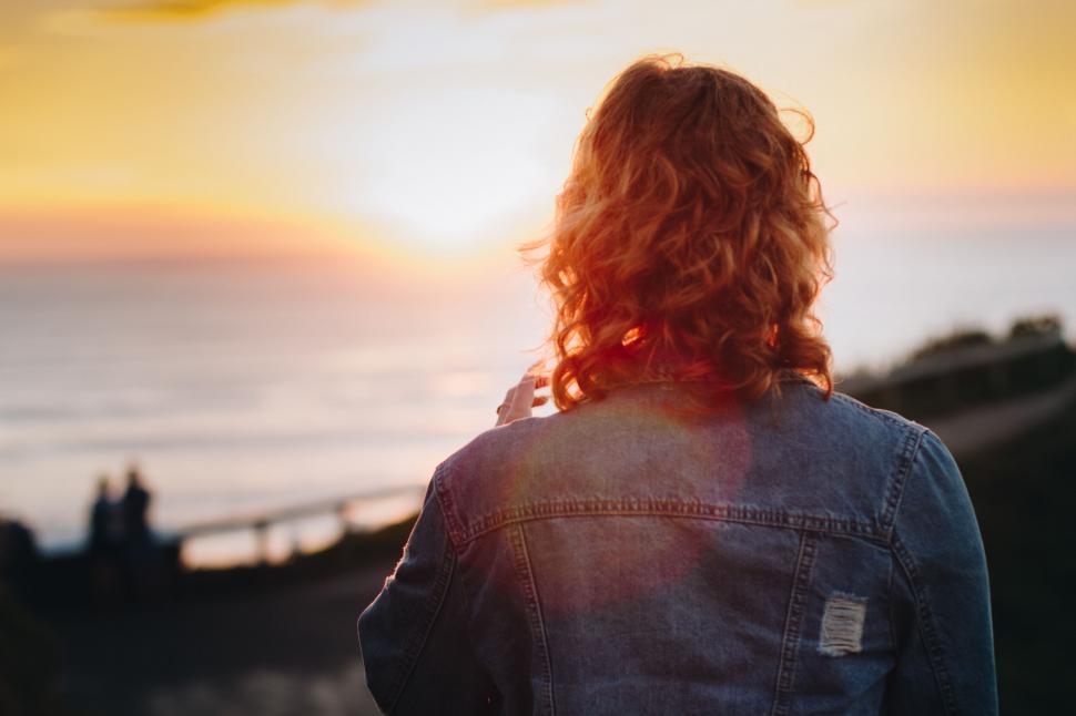 Free Image of Woman Gazing at Ocean Sunset 