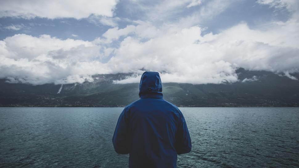 Free Image of Man Standing on Boat Looking Out at Water 