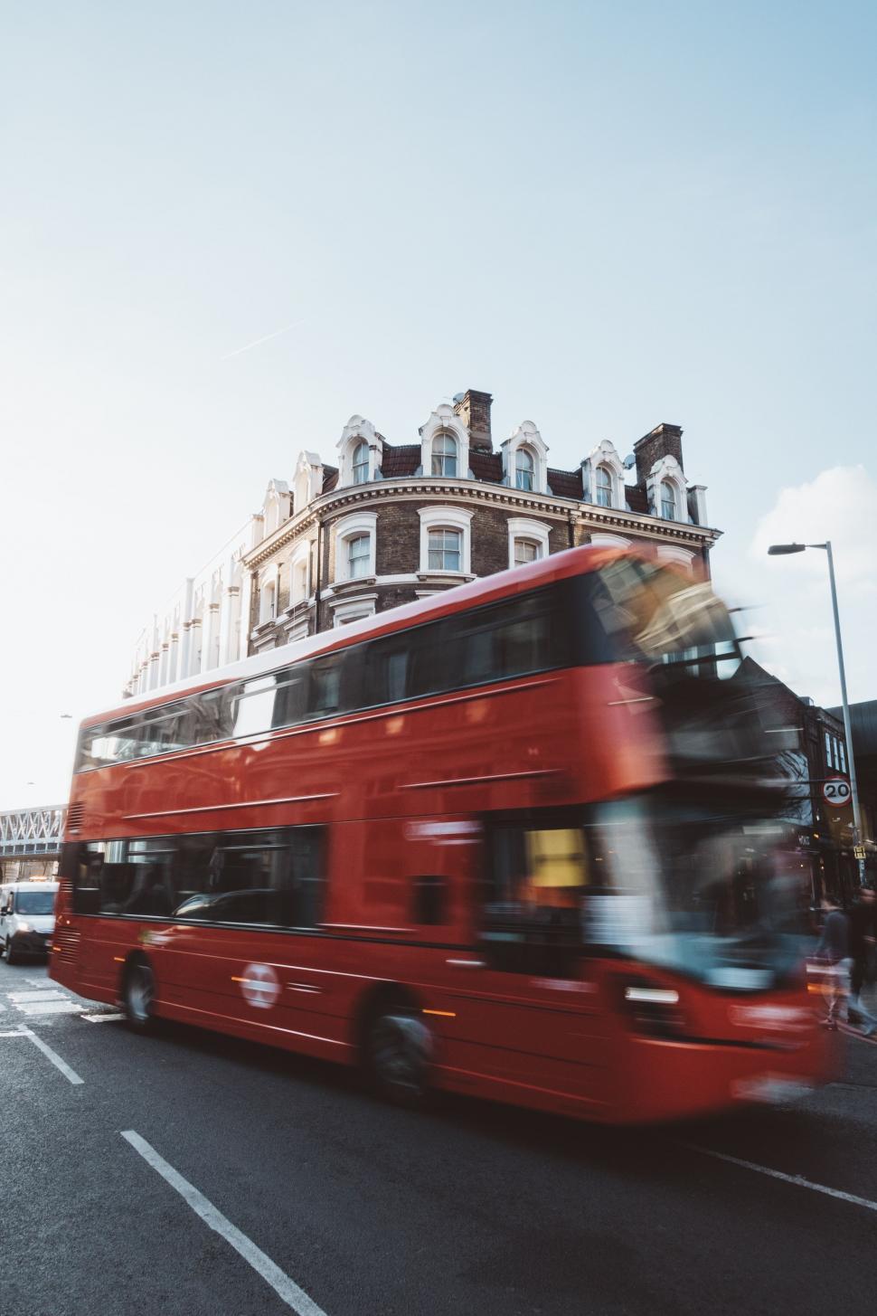 Free Image of Red Double Decker Bus Driving Down a Street 