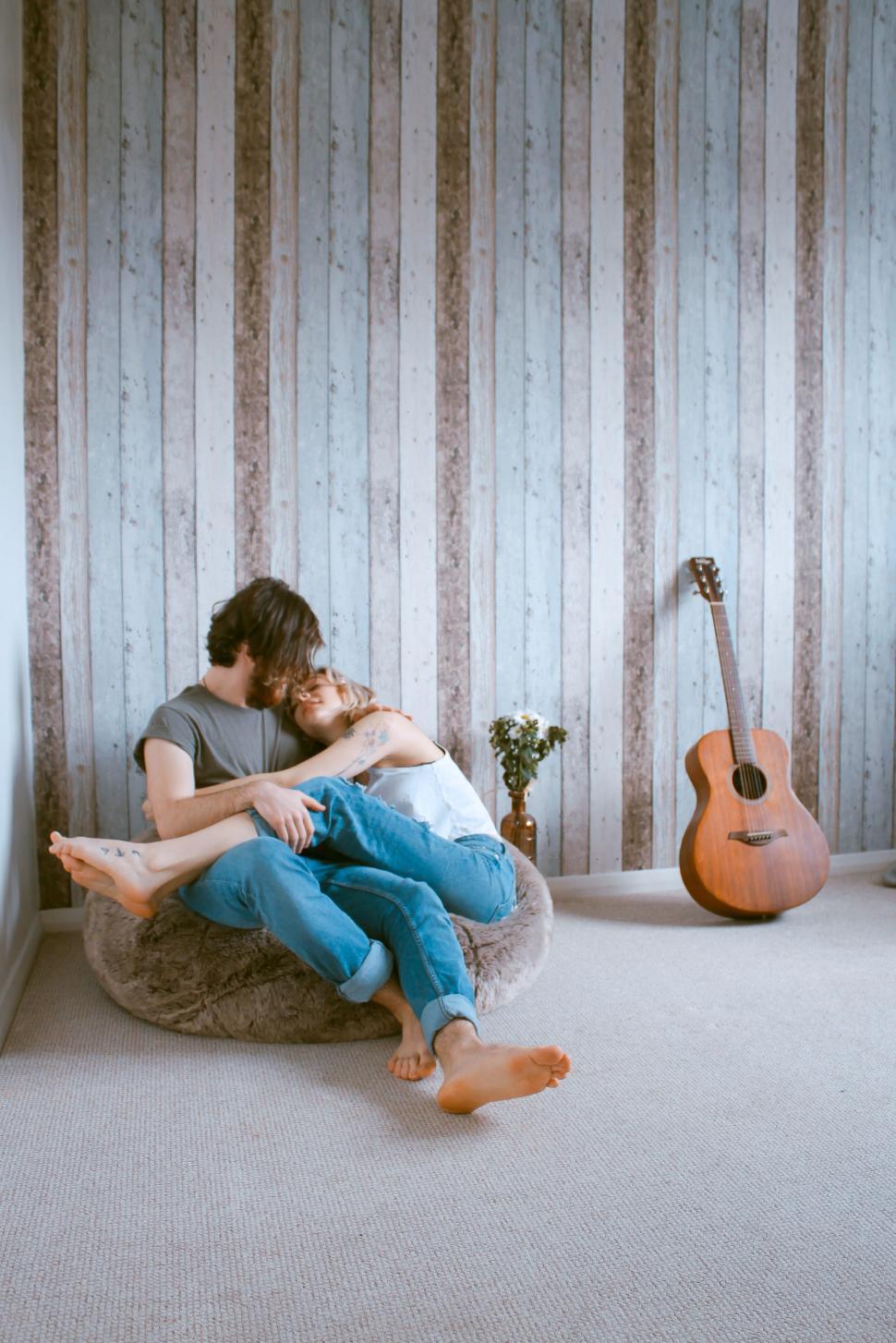 Free Image of Man and Woman Sitting on Bean Bag Chair 