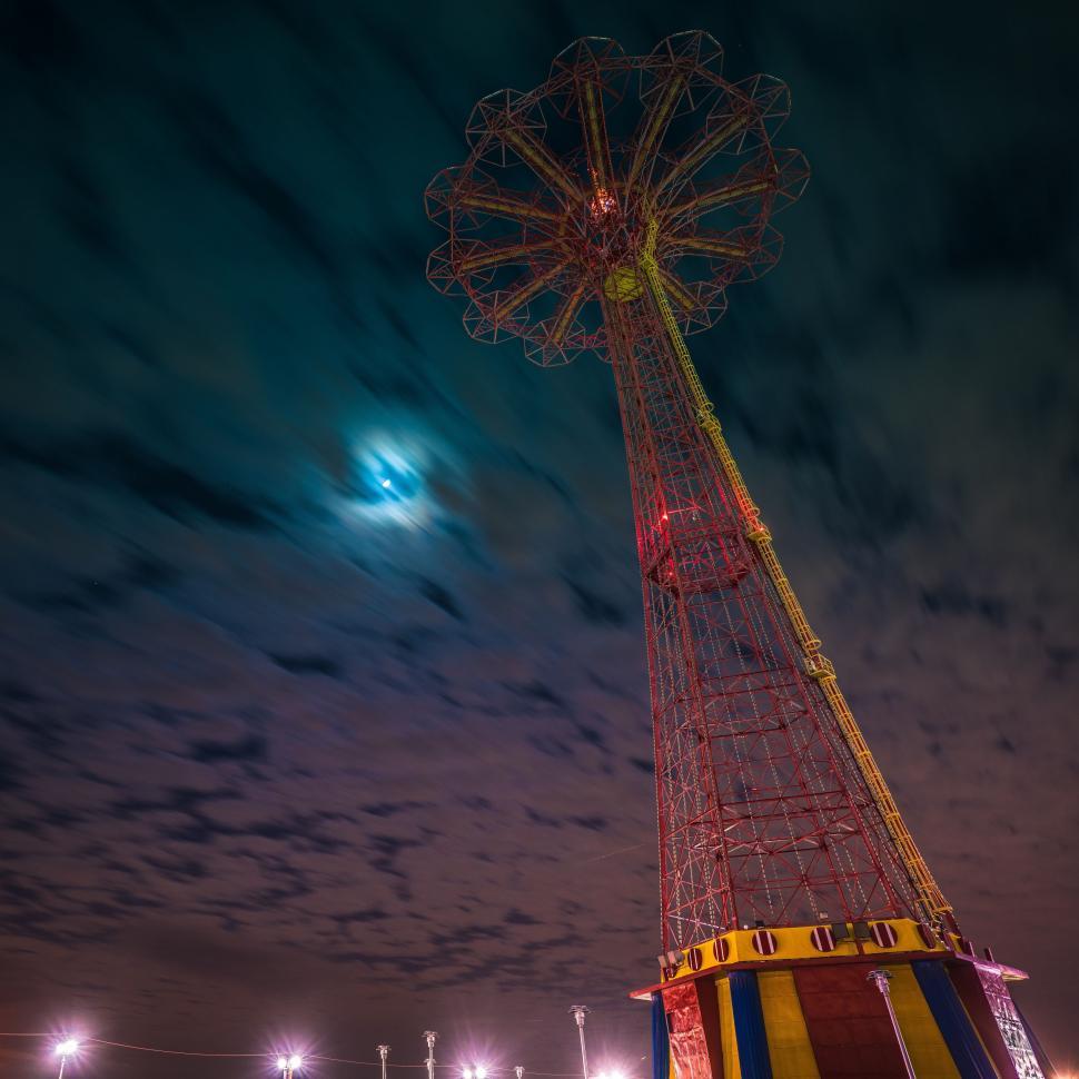 Free Image of Ferris Wheel Spinning Under Full Moon 