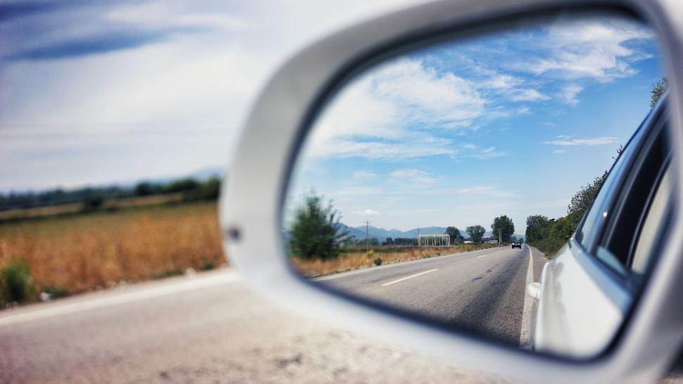 Free Image of Rural Road Reflected in Cars Side View Mirror 