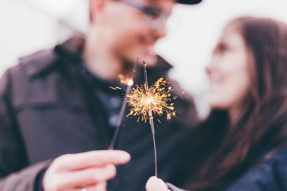 Free Image of Man and Woman Holding a Sparkler 