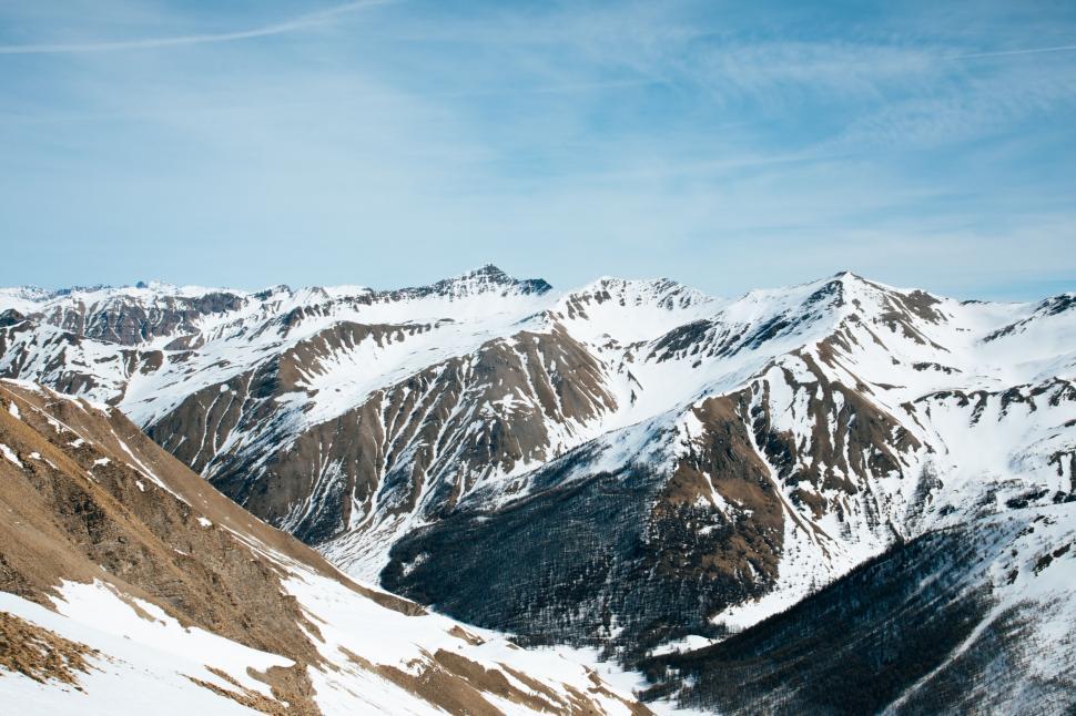 Free Image of Majestic Snow-Covered Mountain Range Under Blue Sky 
