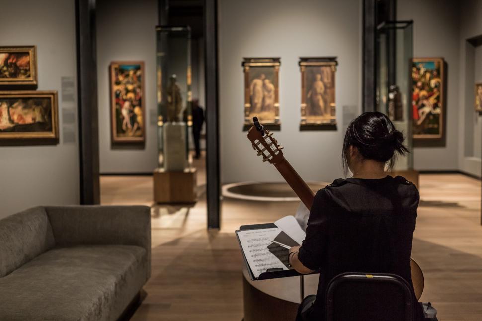 Free Image of Woman Playing Guitar in Museum 
