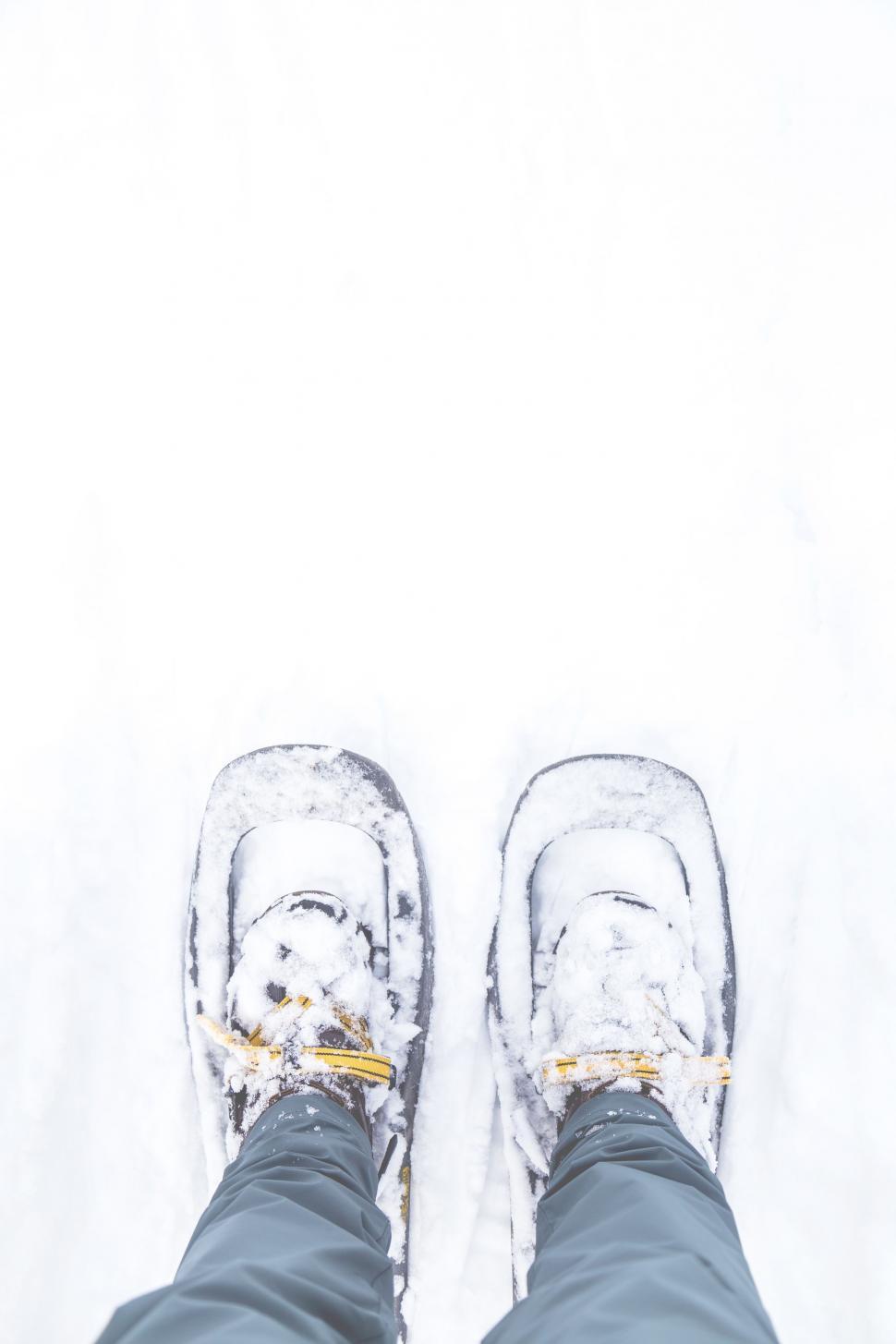 Free Image of Person Standing in Snow With Snow Shoes 