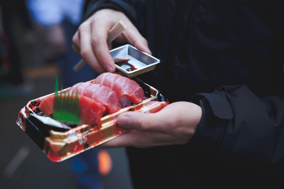 Free Image of Person Holding Piece of Sushi 