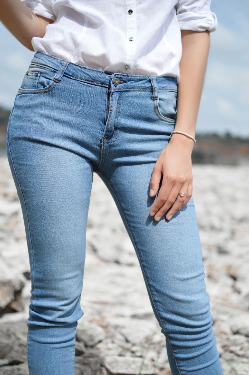 Free Image of Woman in White Shirt and Blue Jeans 
