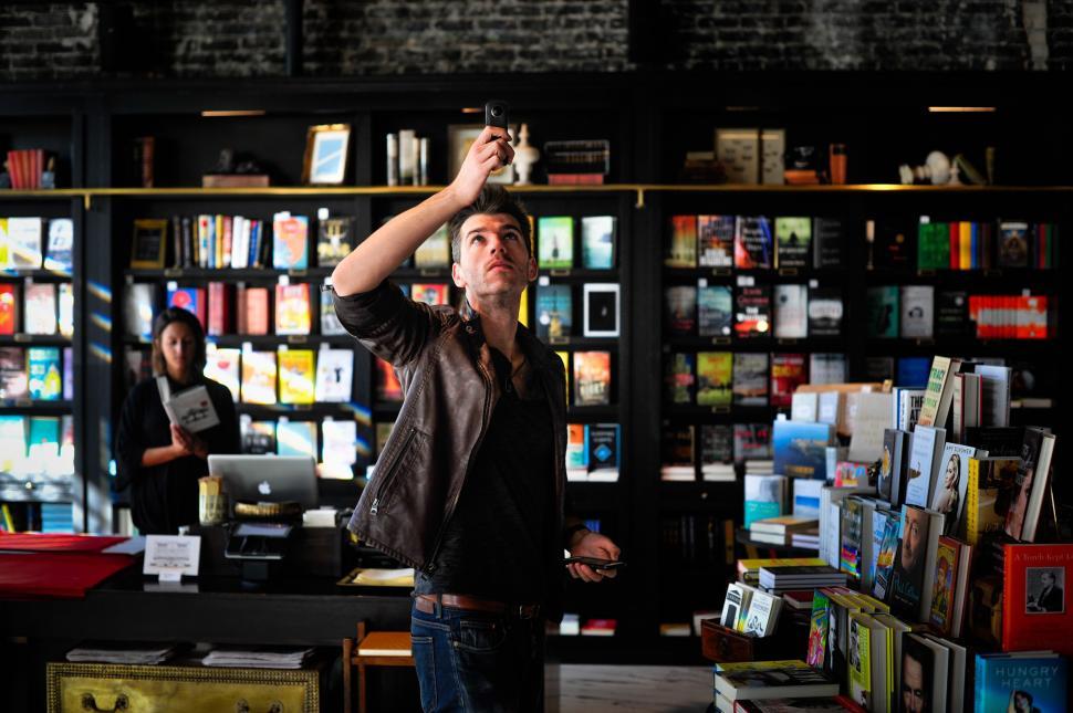Free Image of Man Standing in Front of Bookstore 