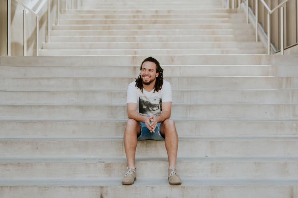 Free Image of Person Sitting on a Set of Stairs 
