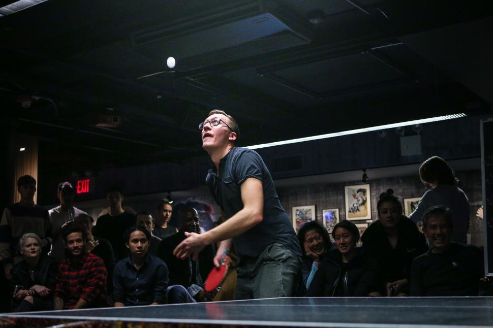Free Image of Man Holding Ping Pong Paddle in Front of Crowd 