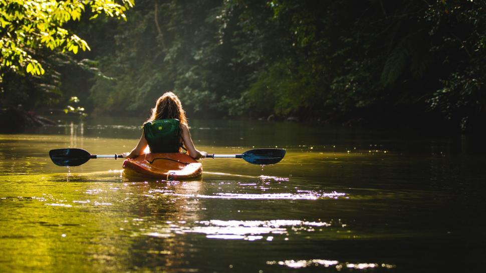Free Image of Woman Kayaking Down River 