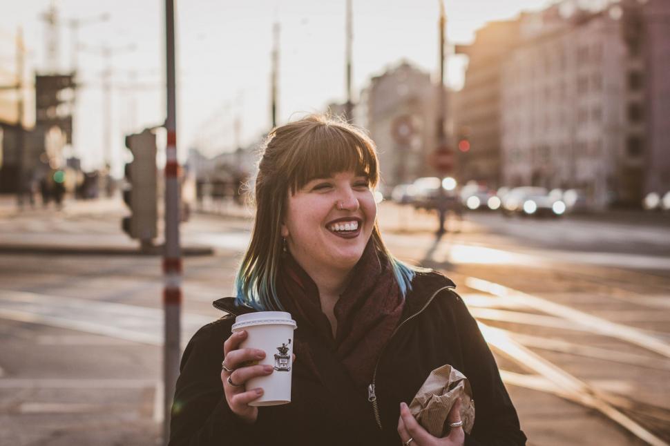 Free Image of Woman Holding a Cup of Coffee and Smiling 