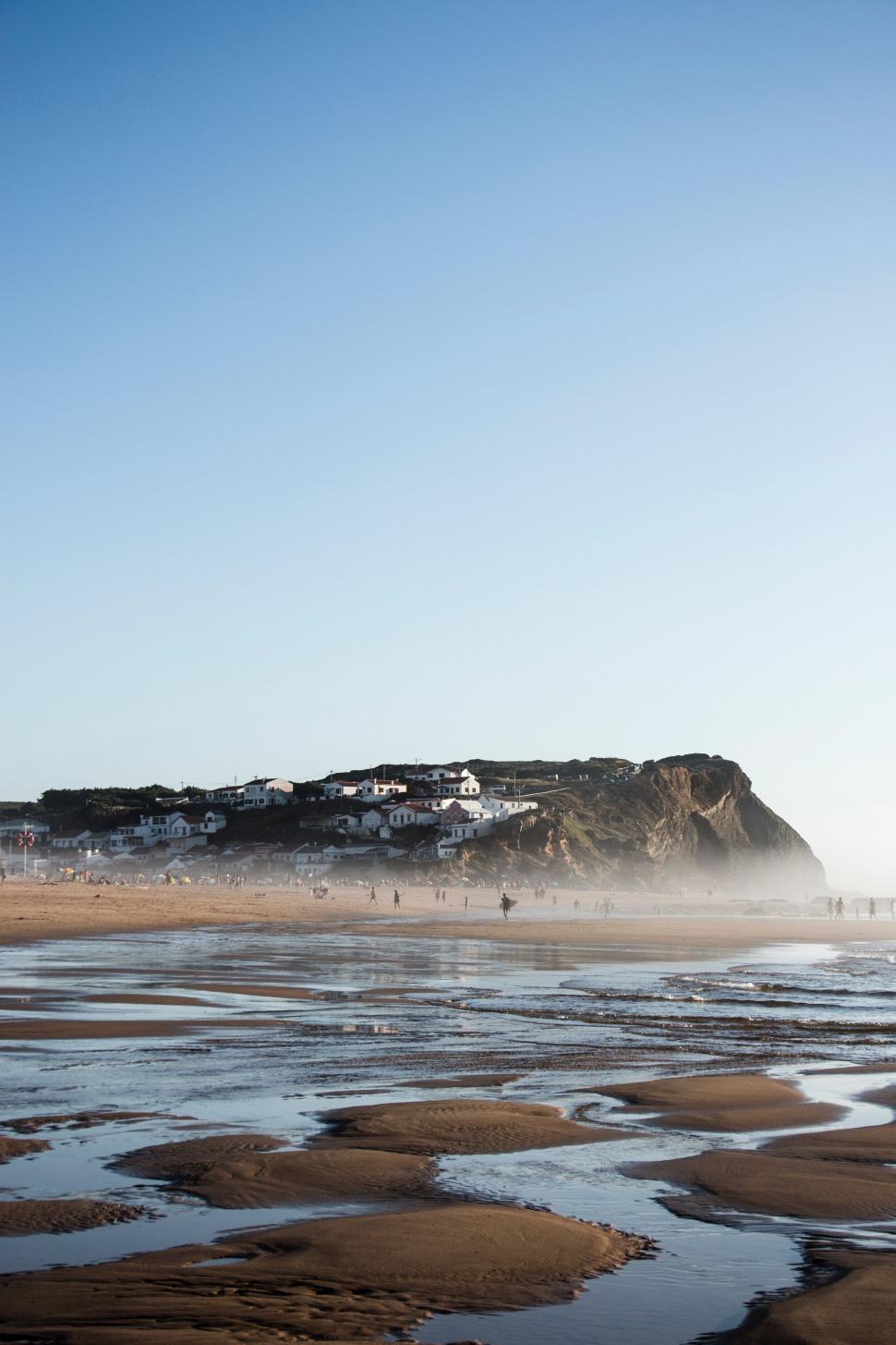 Free Image of Sandy Beach With Hill in Background 