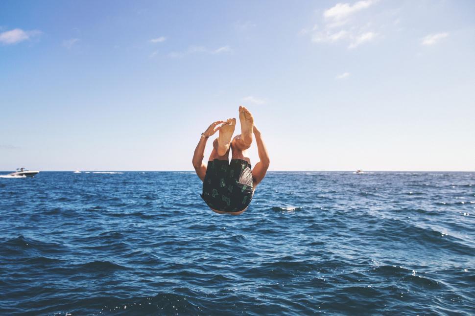 Free Image of Man Diving Into the Ocean From a Boat 