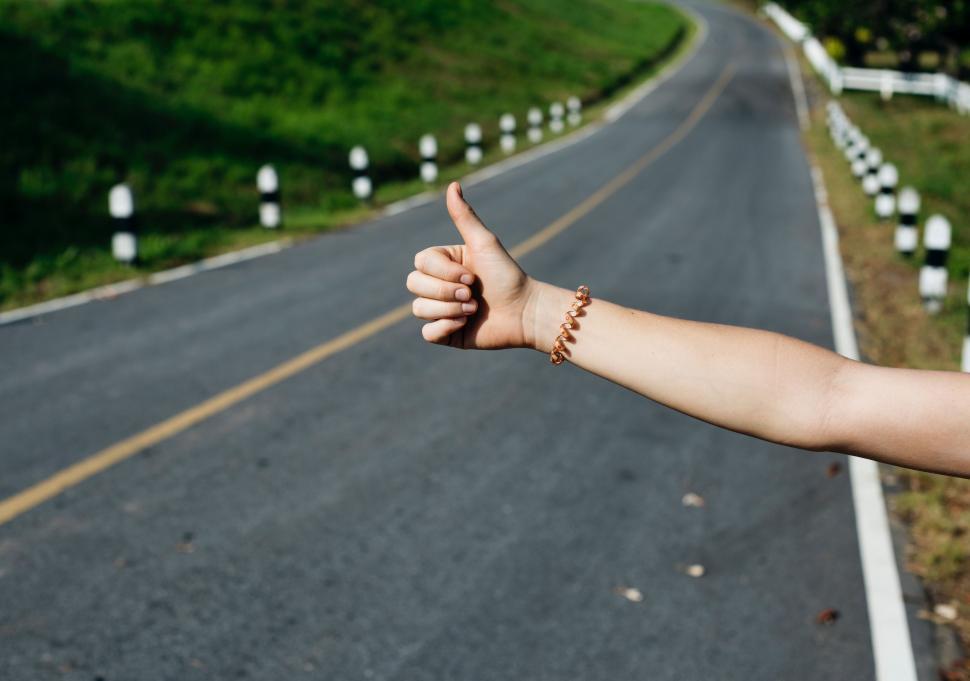 Free Image of Person Giving Thumbs Up on Road 
